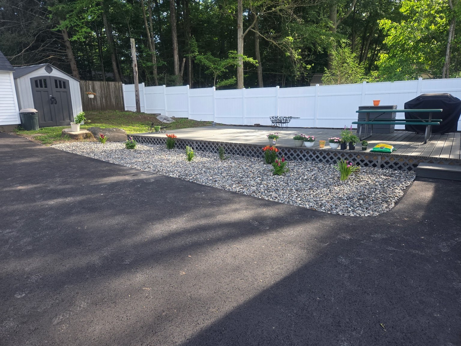 Decorative stone bed and flowers beside the deck